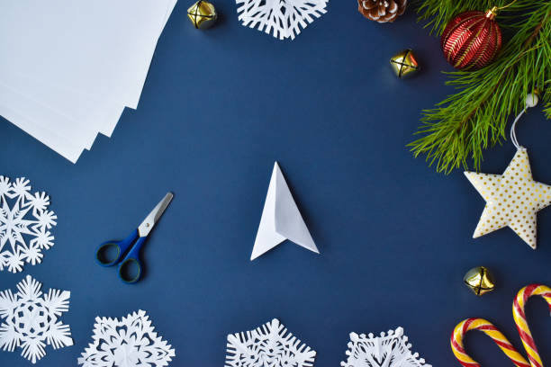 istock Step-by-step instructions. The snowflake is made of paper. Step 6 turn it over and fold it again. Flat lay.Top view 1288804175