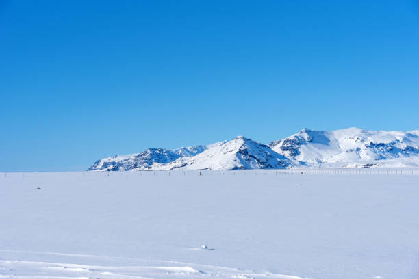 istock Typical Icelandic winter landscape with mountains under the snow and blue sky. 1288804660