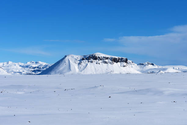 istock Typical Icelandic winter landscape with mountains under the snow and blue sky. 1288804703
