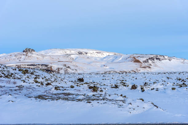 istock Typical Icelandic winter landscape with mountains under the snow and blue sky. 1288804731