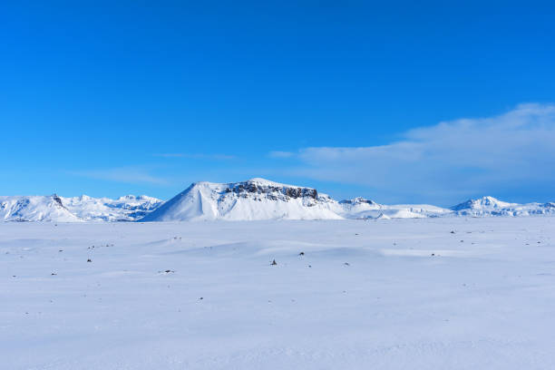 istock Typical Icelandic winter landscape with mountains under the snow and blue sky. 1288804838