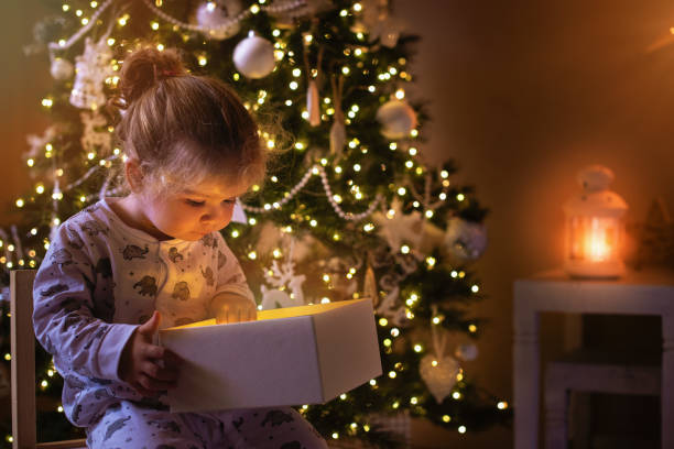 istock Christmas magic, child opening Christmas present 1288807844
