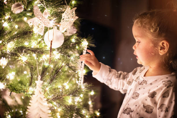 istock Toddler girl decorating Christmas tree 1288809297