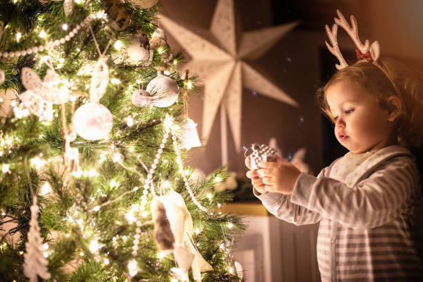 istock Toddler girl decorating Christmas tree 1288809589