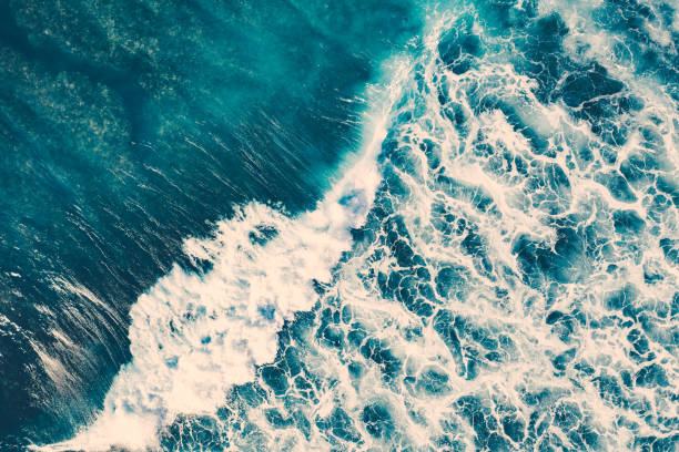 istock Big ocean waves hitting a coral reef. View from above. 1288809595