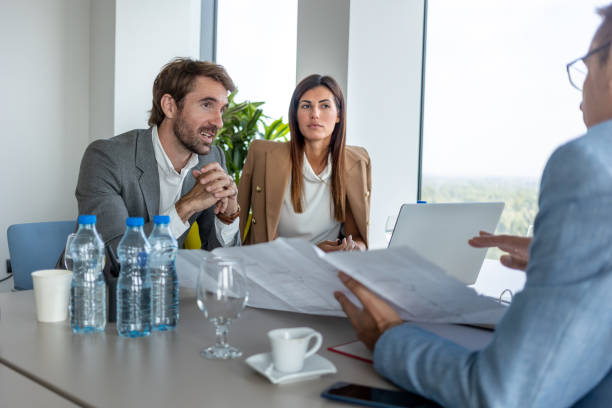 istock Business people discussing plans at the conference table according to chart 1288810644