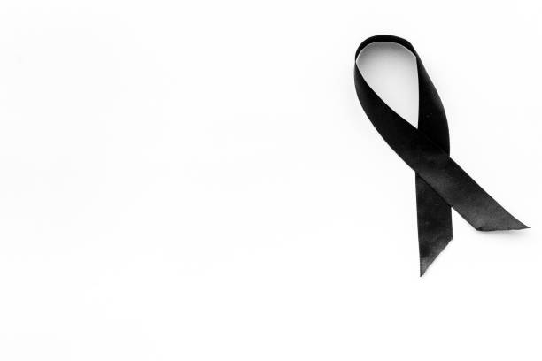 istock Black awareness ribbon isolated on a white background. Top view 1288810820