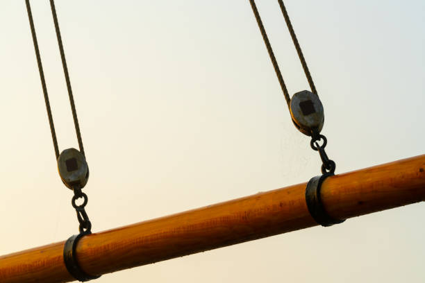 close up of a boom with pulleys on an old wooden tall ship. - sailing ship nautical vessel rigging industrial ship imagens e fotografias de stock