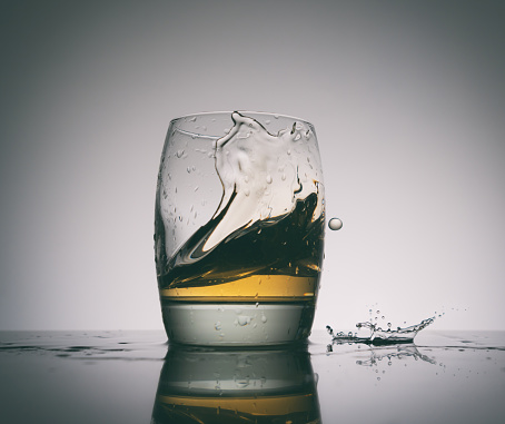 Glasses of brandy with ice cubes isolated on white background