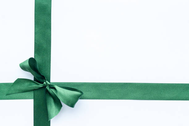 istock Green ribbon with bow isolated on white. Top view, copy space 1288812093
