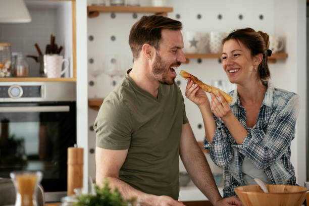 istock Husband and wife making pancakes at home. 1288812115