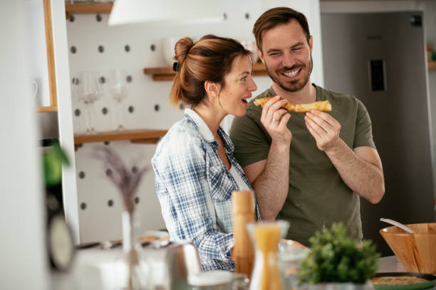 istock Husband and wife making pancakes at home. 1288812188