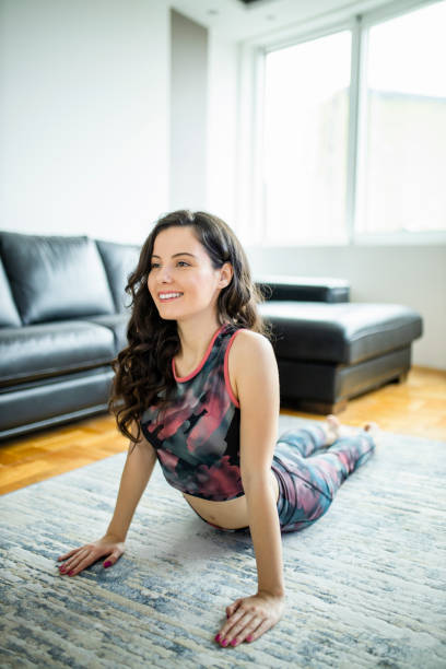 istock Happy smiling woman stretching and practicing at home 1288812790