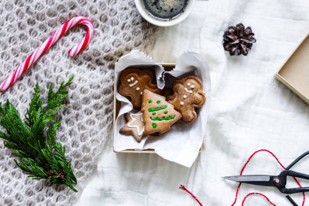istock Homemade gingerbread cookies with icing in a box on a bedspread 1288813029