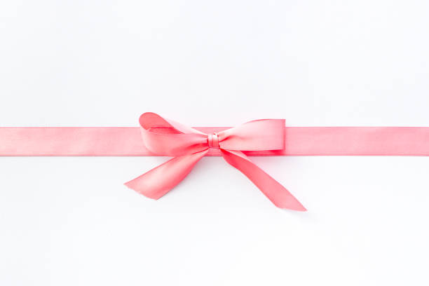 istock Pink ribbon with bow isolated on white. Top view, copy space 1288813203