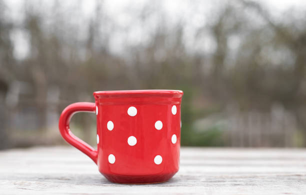 istock Polka dot mug on a wooden table 1288814344