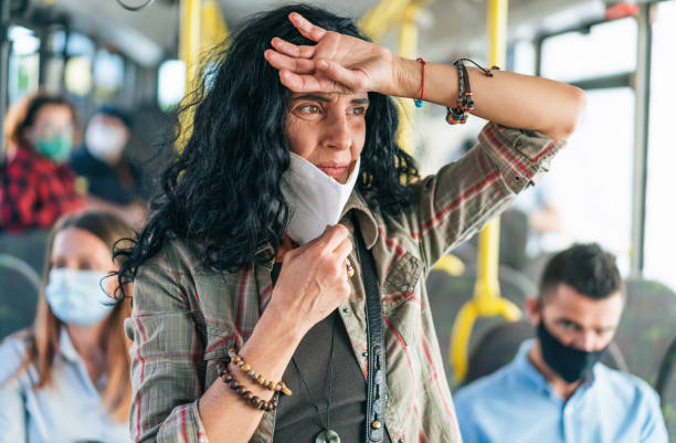 istock Woman gets a panic attack on the bus while wearing a protective mask during COVID-19 1288815349