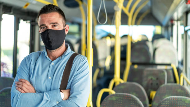 istock Men with protective face mask traveling with bus, during COVID-19 1288815360