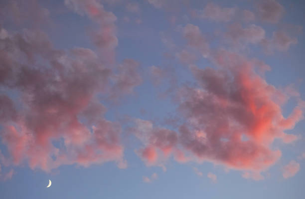 istock Moon with blue pastel skies and pink and gray clouds 1288815963