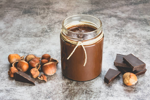istock Homemade hazelnut chocolate butter, hazelnut, dark chocolate, on black stone background 1288816782