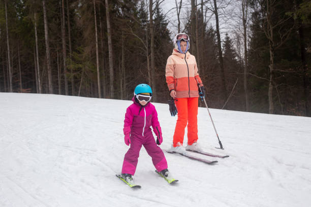 istock The child is skiing with his mother. 1288816911