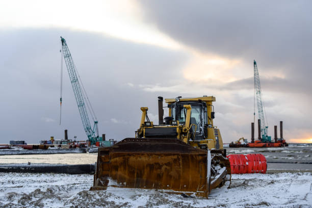 istock Construction Marine offshore works. Dam building, crane, barge, dredger. Breakwater construction. 1288817476