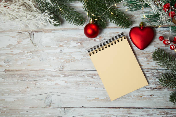 istock spiral notepad on wooden background with christmas decorations 1288818039