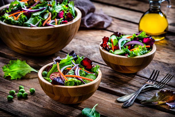 istock Frash salad bowls shot on rustic wooden table 1288818050