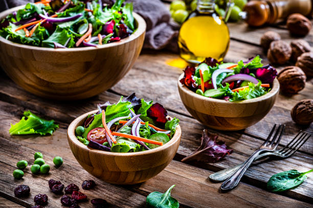 istock Frash salad bowls shot on rustic wooden table 1288818076