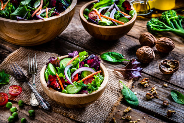 istock Frash salad bowls on rustic wooden table 1288818082