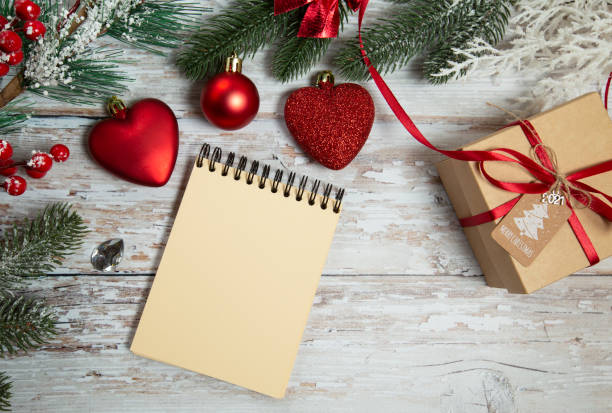 istock spiral notepad on wooden background with christmas decorations 1288818364