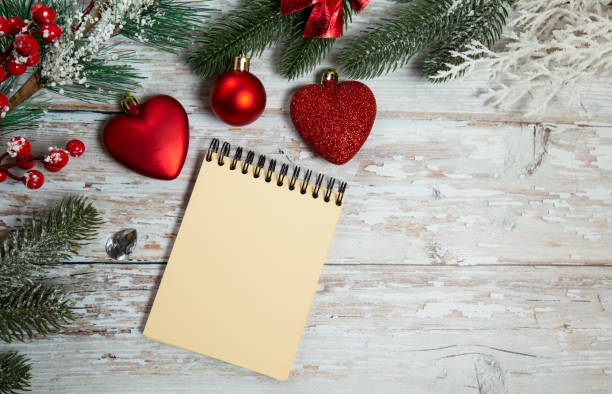 istock spiral notepad on wooden background with christmas decorations 1288818444