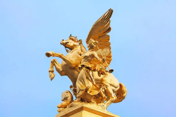 Golden statue of Pegasus held by Fame . Statue on the Pont Alexandre III in Paris