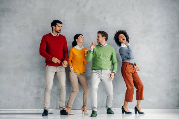 istock Four cheerful playful successful business people dancing. 1288823456