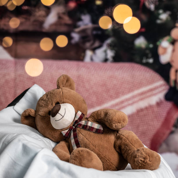istock cute teddy bear on the Christmas decorations background 1288823549