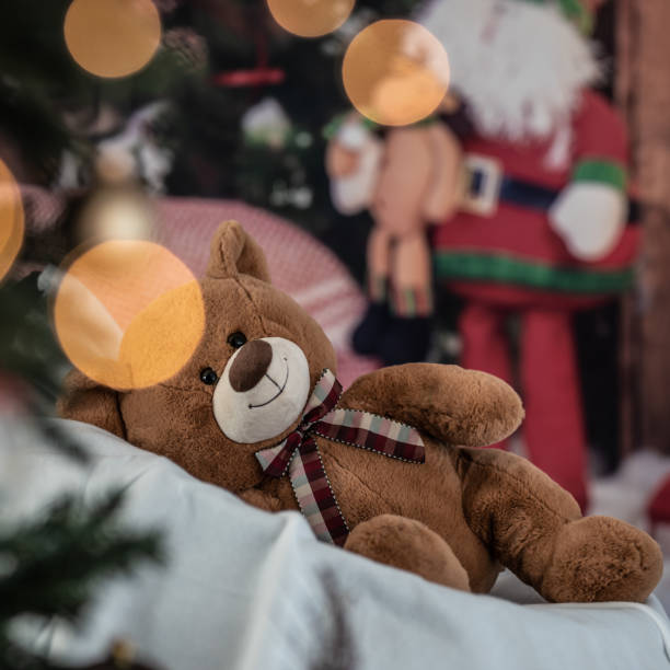 istock cute teddy bear on the Christmas decorations background 1288824223