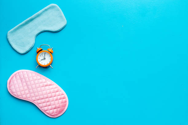istock Sleeping mask with alarm clock, flat lat,top view 1288825972