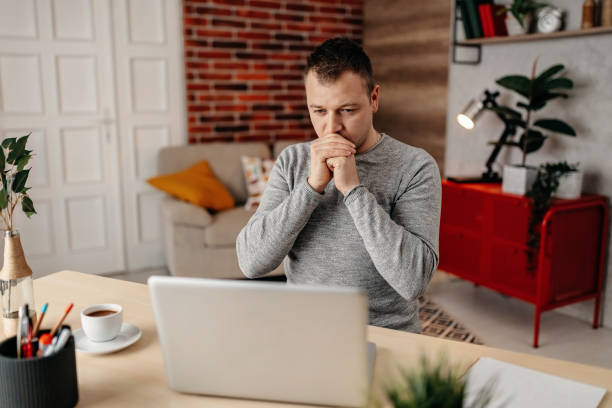 istock Pensive man work at laptop at home 1288826469