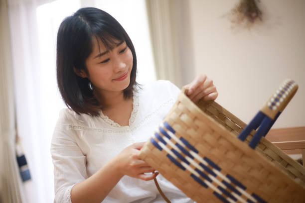 istock A woman making a basket with a craft band 1288828158