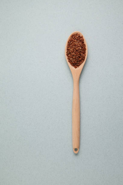istock Brown rice. GABA rice in wooden spoon on light textured background. Top view, place for text 1288828472