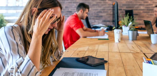 istock Stressed businesswoman with hands on head 1288828521