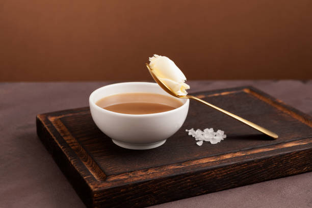 традиционный тибетский чай масло или вспененный чай в белой миске. азиатский напиток, известный как "po cha" смесь черного чая як масло и соль. � - churned стоковые фото и изображения