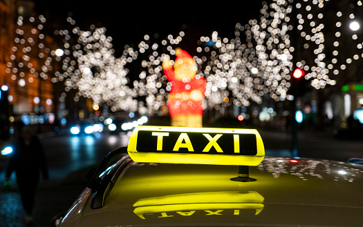 Yellow Taxi cab on the street near Christmas market in Berlin, Germany