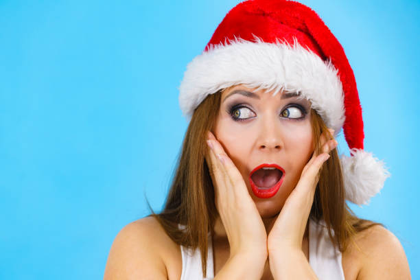 istock Surprised woman in santa claus hat 1288829457