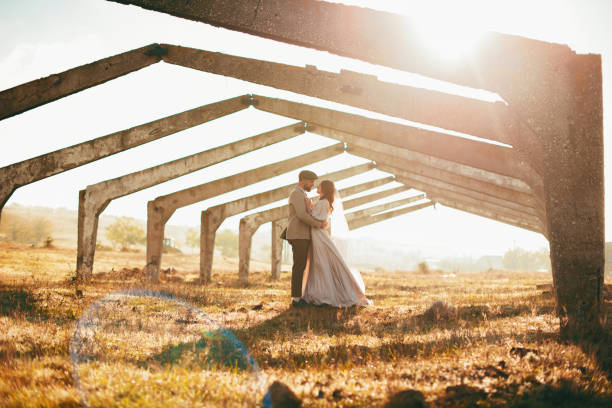 istock Young bride and groom couple on a field. 1288832270