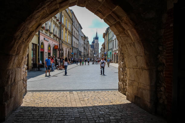 la entrada del arco en la puerta de san florián a la calle florianska en el casco antiguo de cracovia, polonia - florianska street fotografías e imágenes de stock