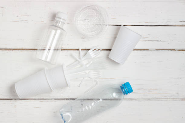istock Plastic dishes, bottles, glasses on a white table. Planet pollution 1288841034