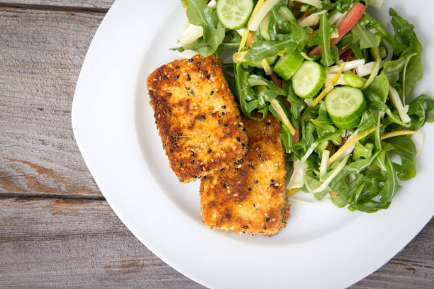 istock deep fried in bread crumb tofu slices with salad 1288842166