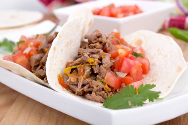 pork or beef cornita taco with pico de gallo closeup