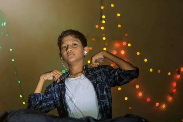 istock Cute Indian little child showing expression over lighting background 1288842758